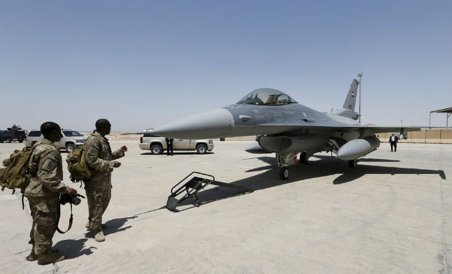 Militares norte-americanos obsevam jato F-16 na base em Balad em 2015 — Foto: Reuters 