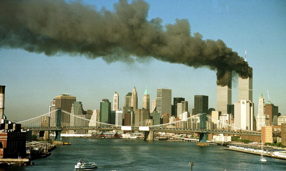 A September 11, 2001 file photo shows the towers of New York's World Trade Center pour smoke shortly after being struck by hijacked commercial aircraft. New York City plans to mark the third anniversary of the attacks on the trade center with an observanc