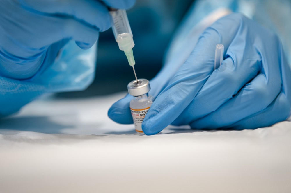(FILES) In this file photo taken on November 24, 2021 a nurse prepares the Pfizer-BioNTech Covid-19 vaccine for children for distribution in Montreal, Quebec. - The Canadian province of Quebec, crippled by the Omicron variant, will impose a new health tax